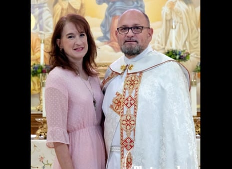 A woman and a man in religious vestments smile.